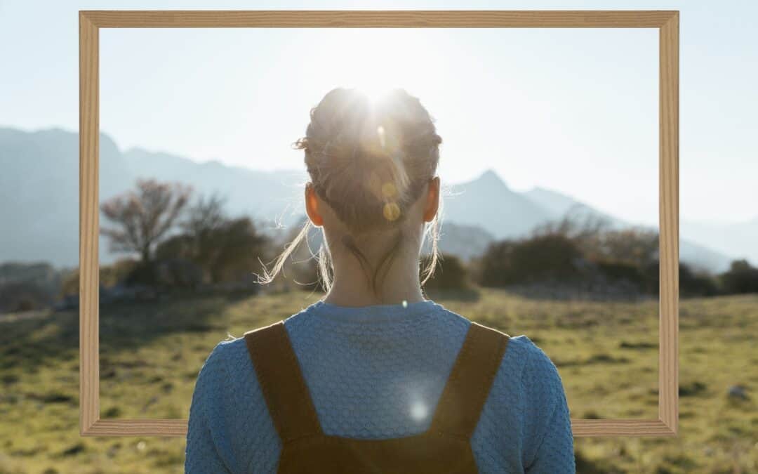 Woman framed by scenic landscape and sunlight