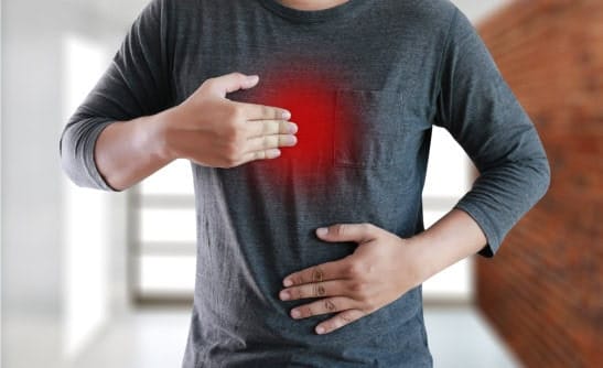 Person experiencing acid reflux or heartburn